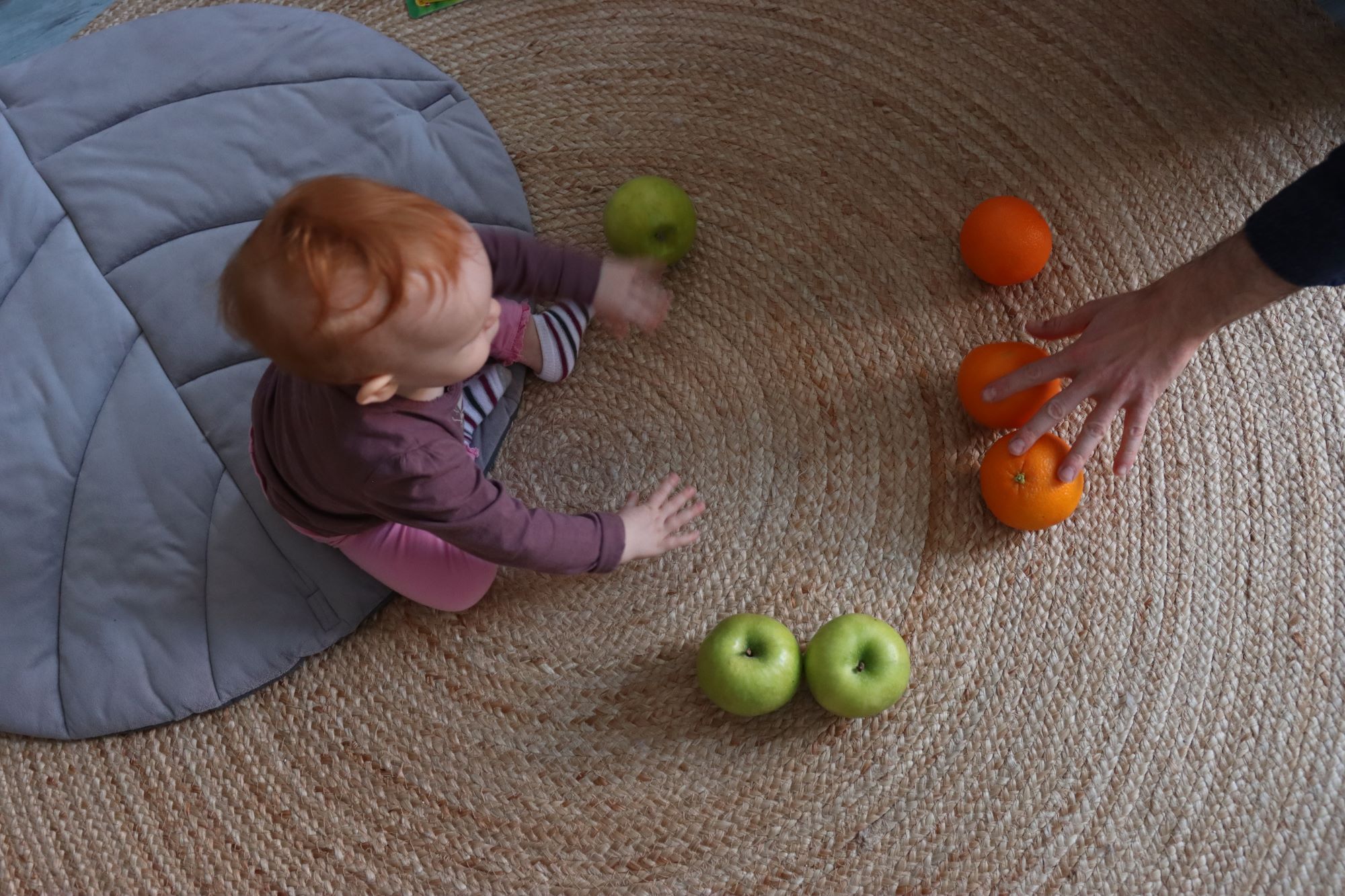 Baby learning words and numbers through play with their caregiver. Photo: Peter Lengyel-Szabo
