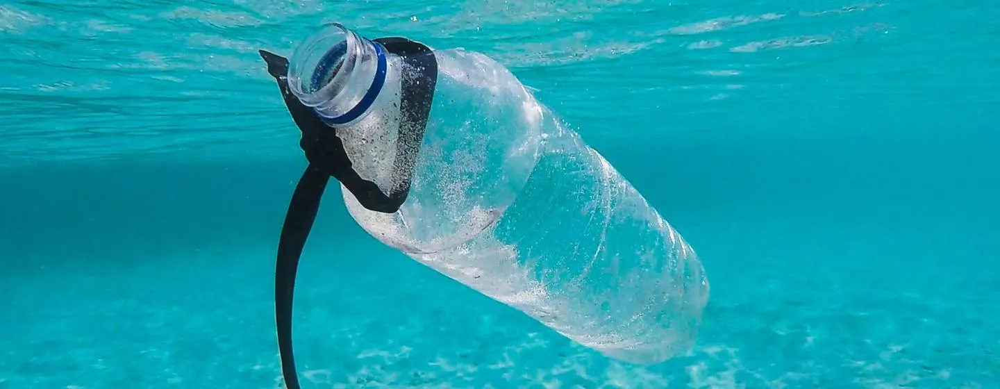 Plastic bottle floating in blue water