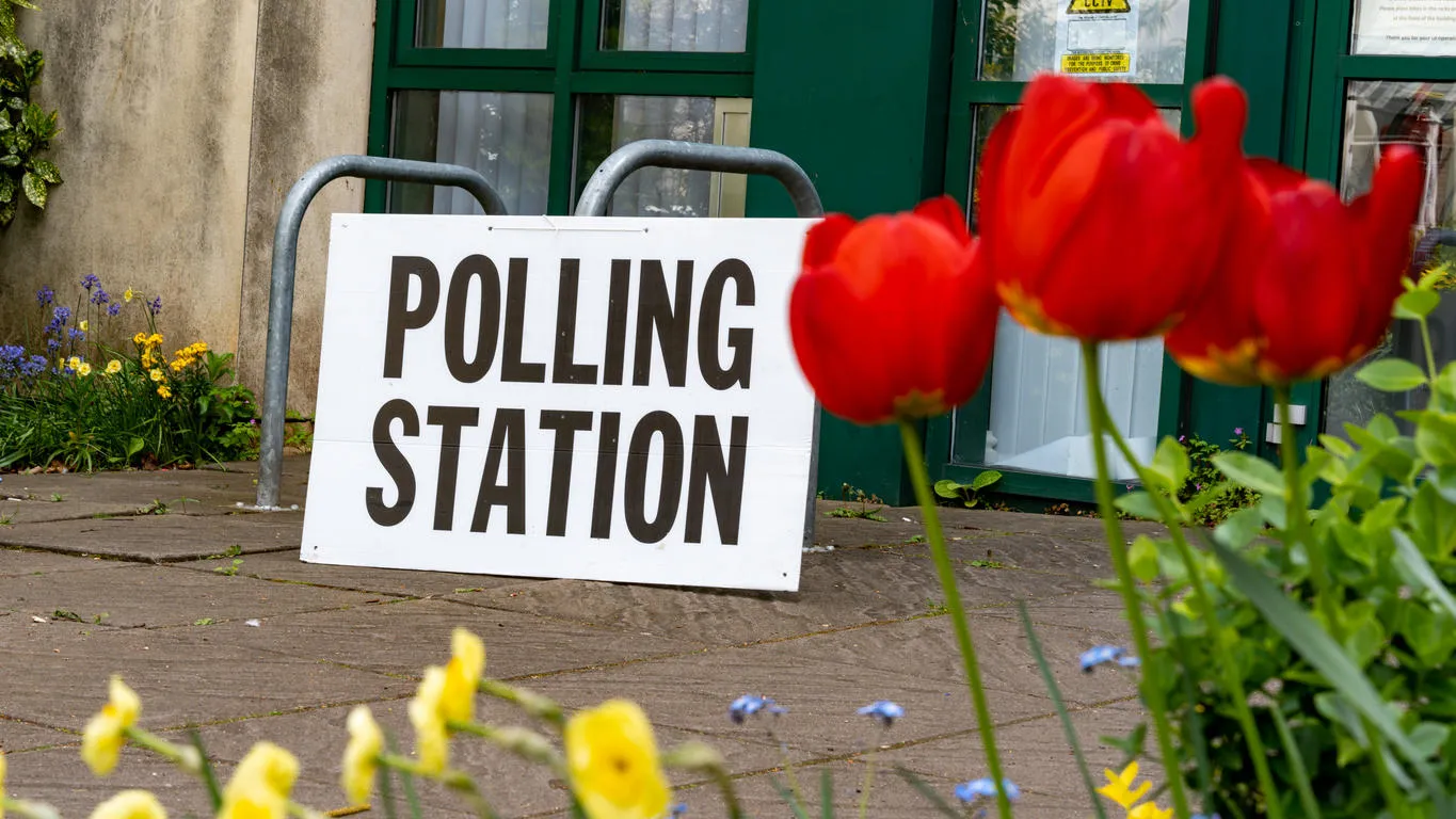 External shot of a polling station, with polling station sign.