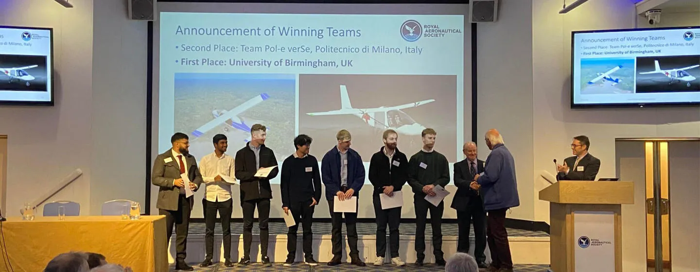 Birmingham aerospace students accepting a prestigious international light aircraft design competition prize on stage
