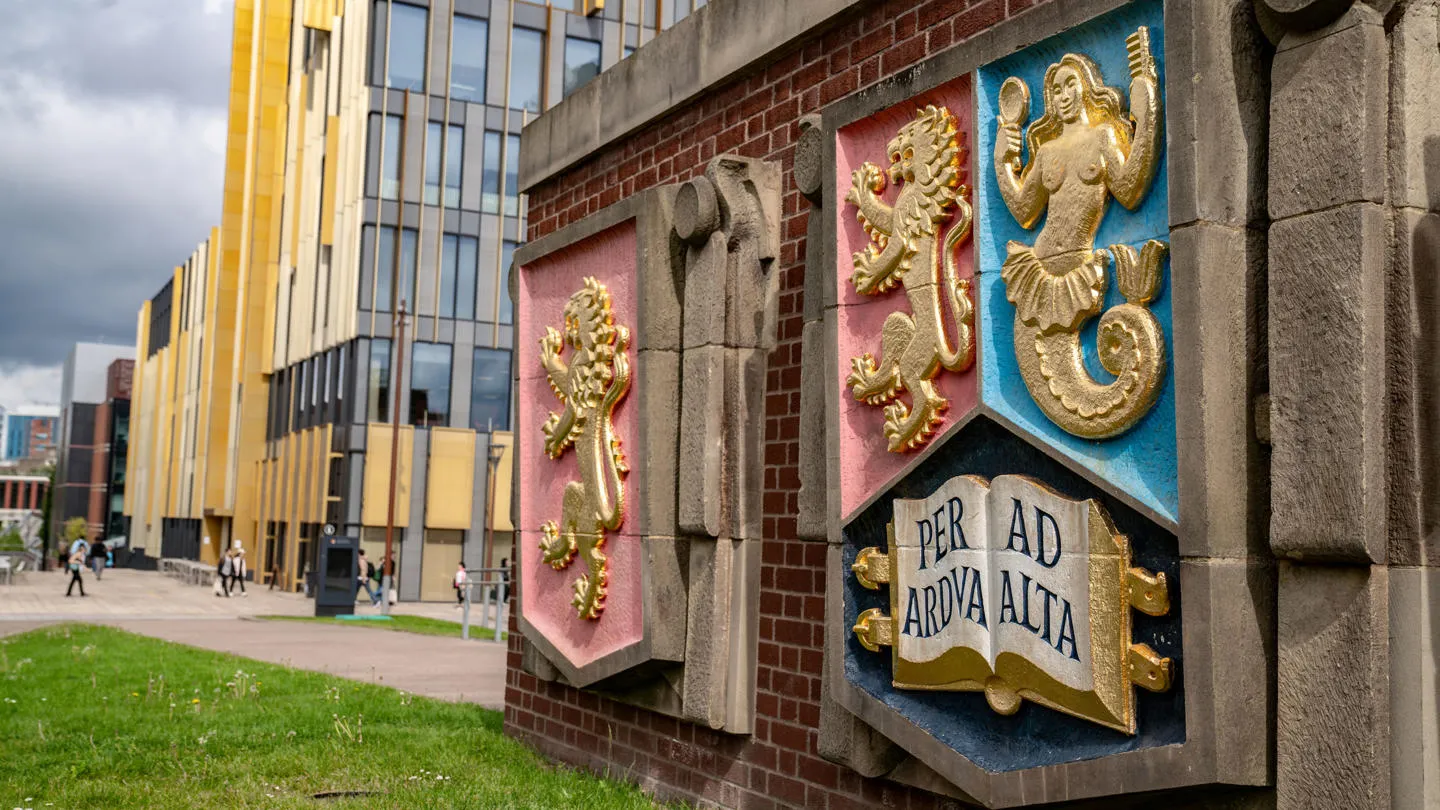 University of Birmingham crest outside the library on campus.