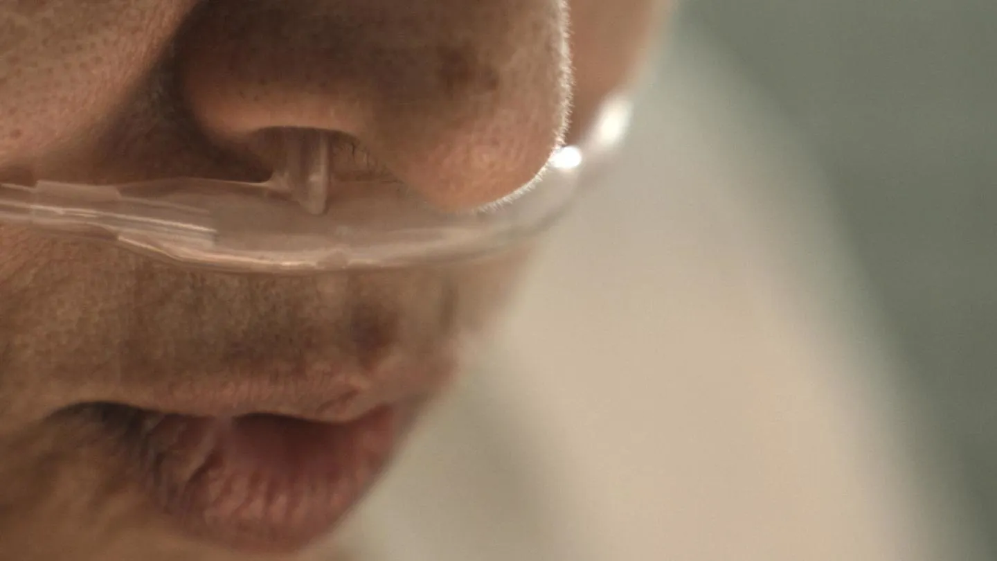 Caption: A still taken from the IPF film. A woman’s face with a nasal cannula. 