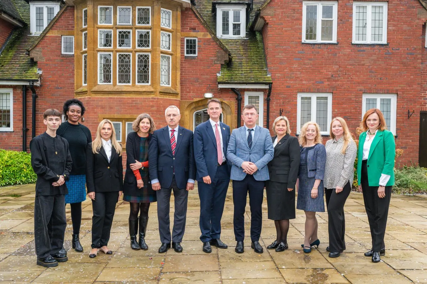 Group of academics and students standing in front of Hornton Grange, at the University of Birmingham