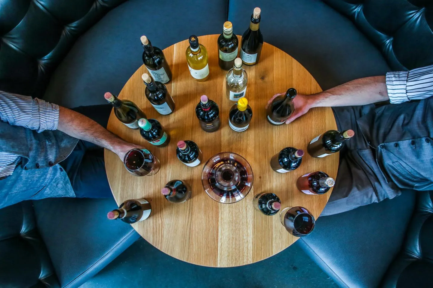 Circular table full of wine bottles