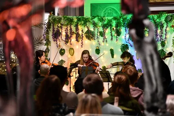 A string quartet play beneath Roary the Allosaurus.