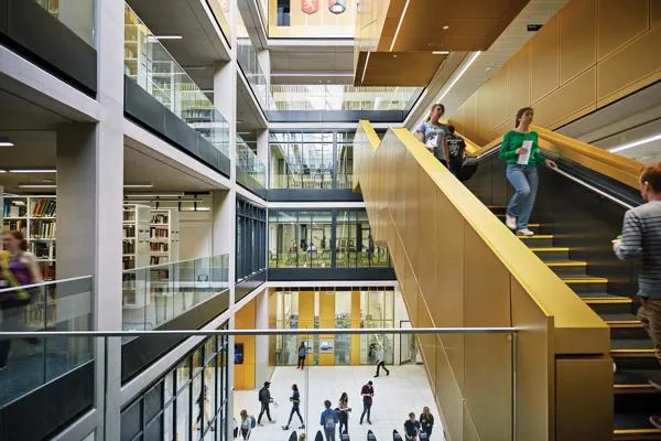 Student walking down the main staircase inside the library