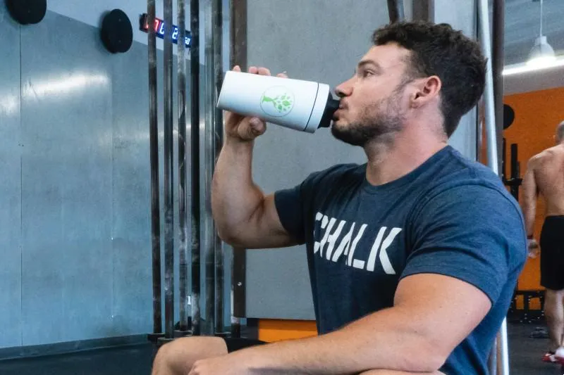 Man drinking protein shake in a gym