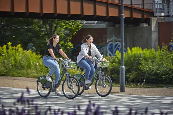 Students using a hire bike to get around the local area