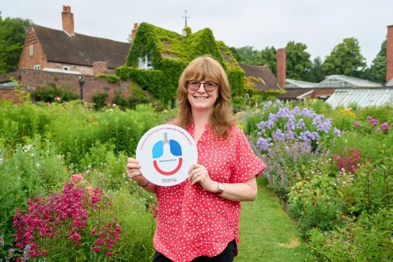 Tessa Lovell holding award for Winterbourne House and Garden voted favourite place to 'take a breath'.